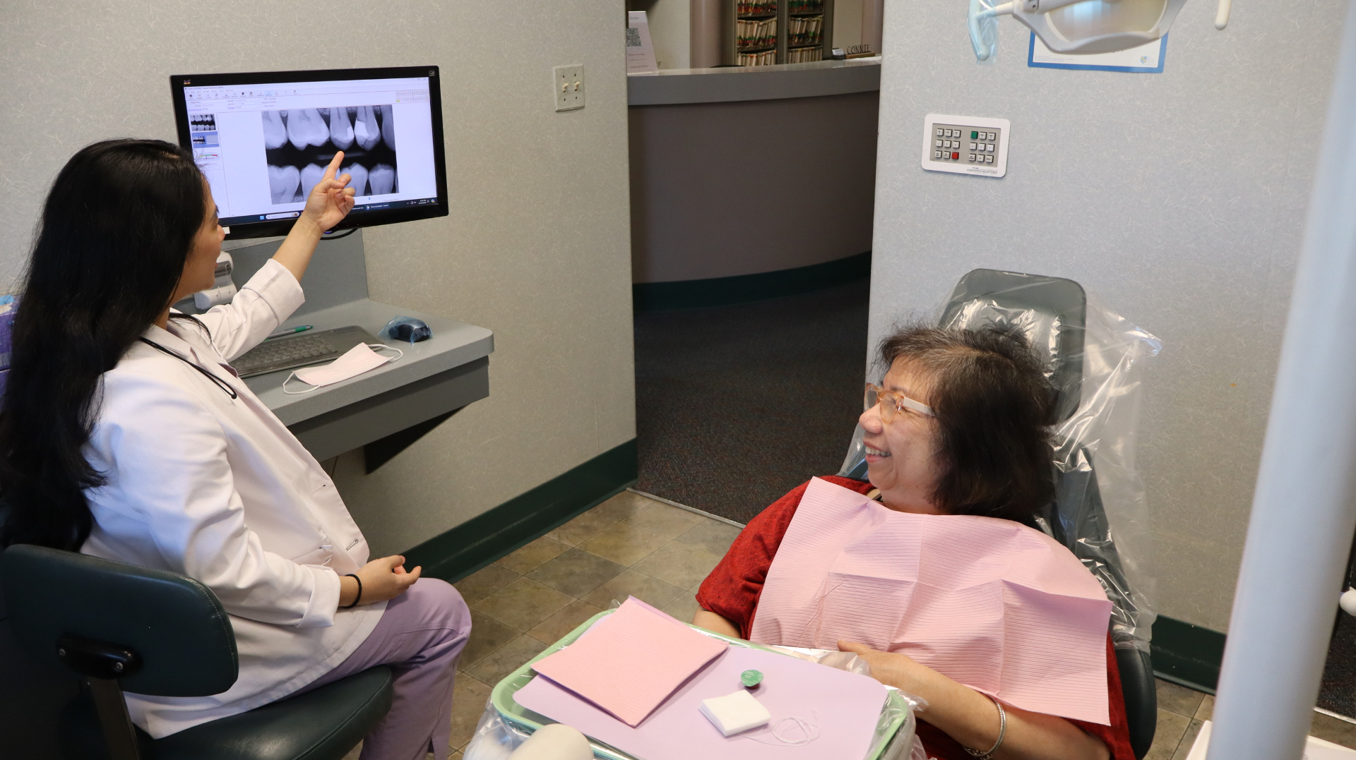 Dr. Cacho reviewing a patient's x-ray on a chairside monitor