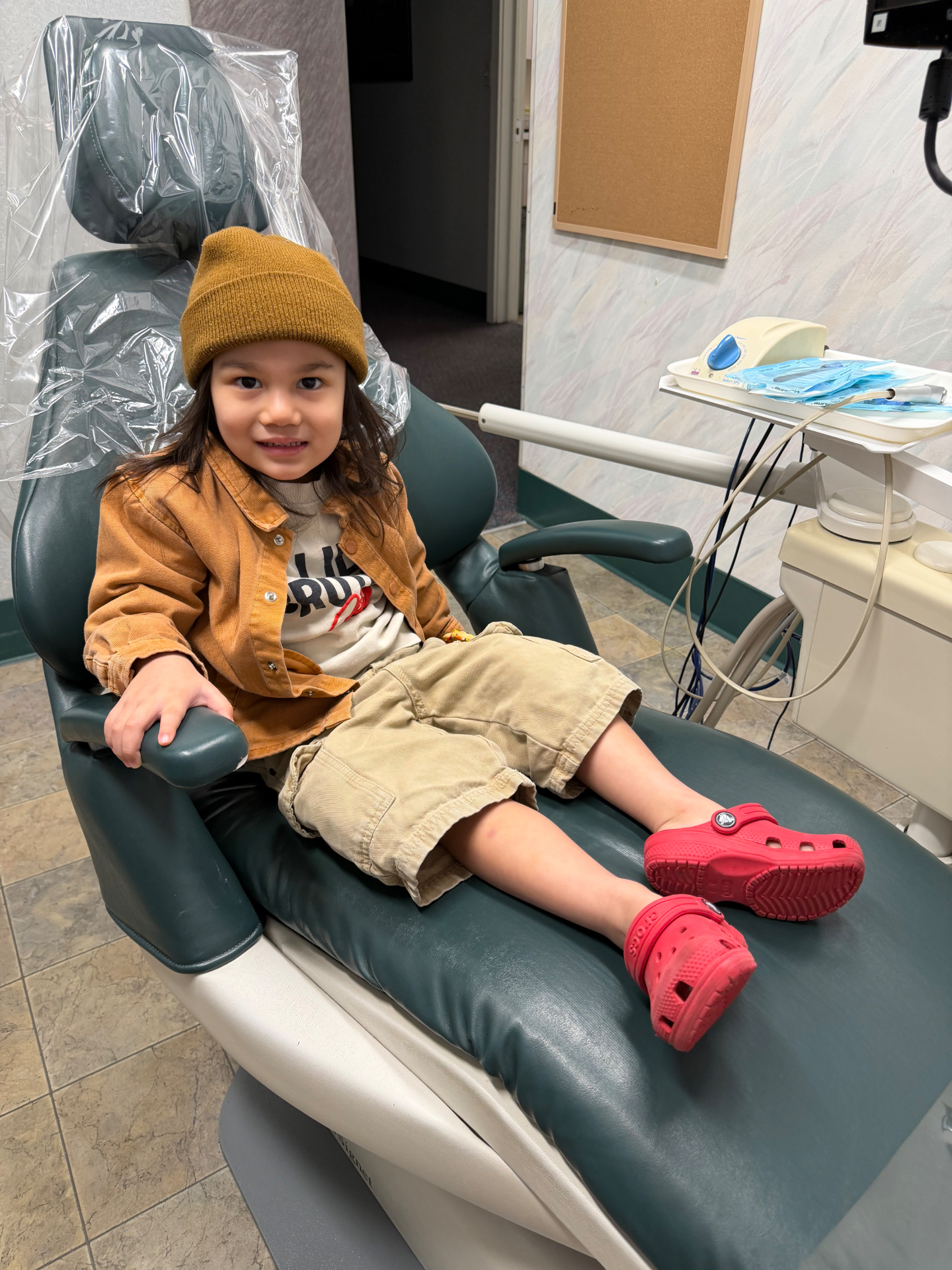 Happy child relaxing in the dental chair