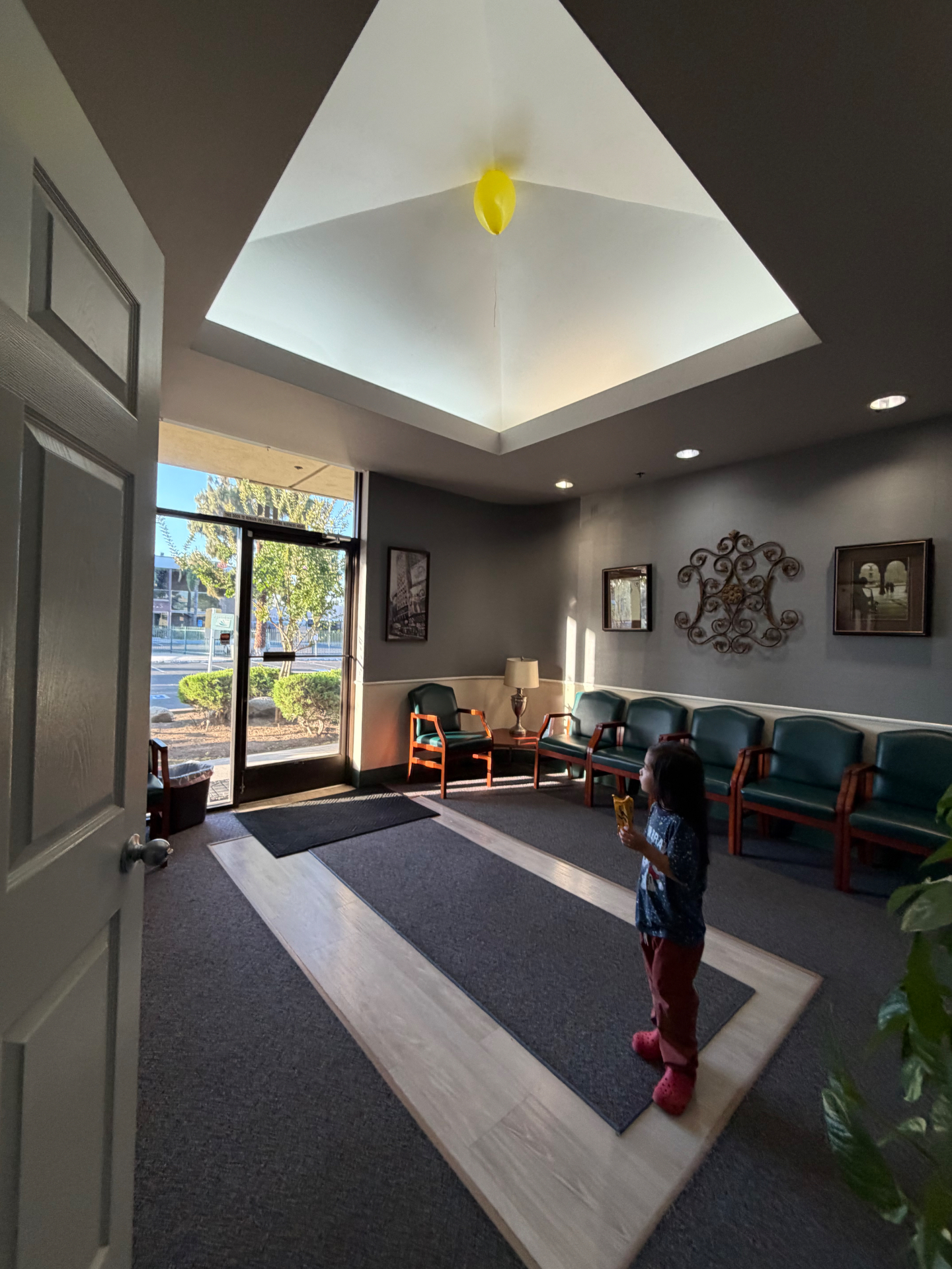 Sunlit waiting room with skylight and comfortable seating